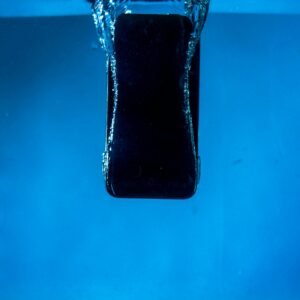 A smartphone partially submerged in water, captured against a blue backdrop.